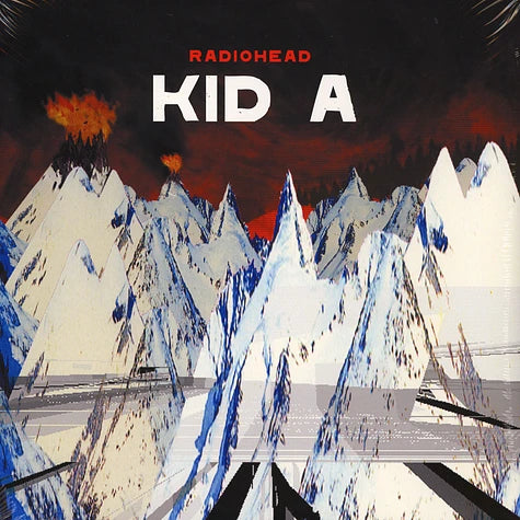 Album cover for Radiohead's 'Kid A' with stylized mountains and fiery sky.